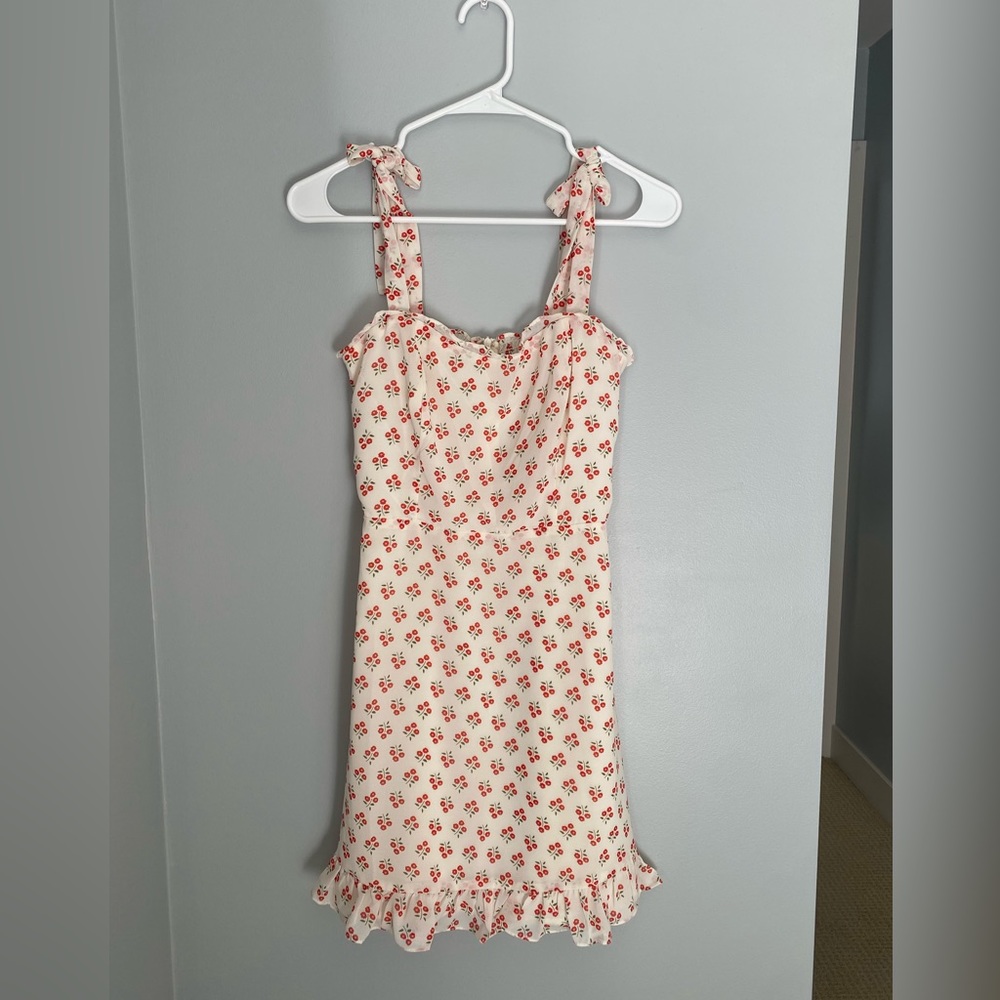Cream and red flower dress with adjustable tie straps and side zipper.